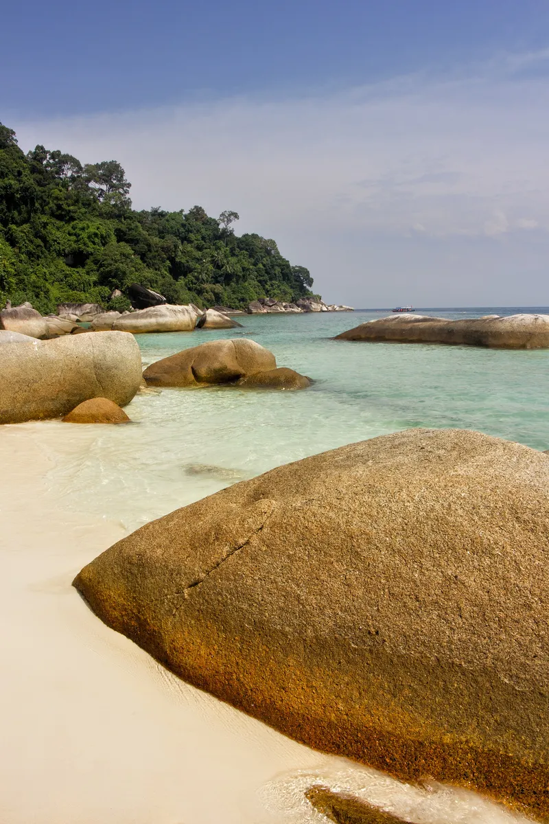 Rocky shore and white sand beach. Perhentian Islands. Malaysia